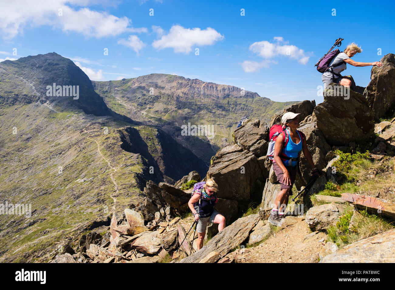 Les randonneurs et des mains sur les roches jusqu'Lliwedd Y dans Snowdon horseshoe en montagnes de Snowdonia National Park (Eryri). Mcg Llançà, Gwynedd, Pays de Galles, Royaume-Uni, Angleterre Banque D'Images