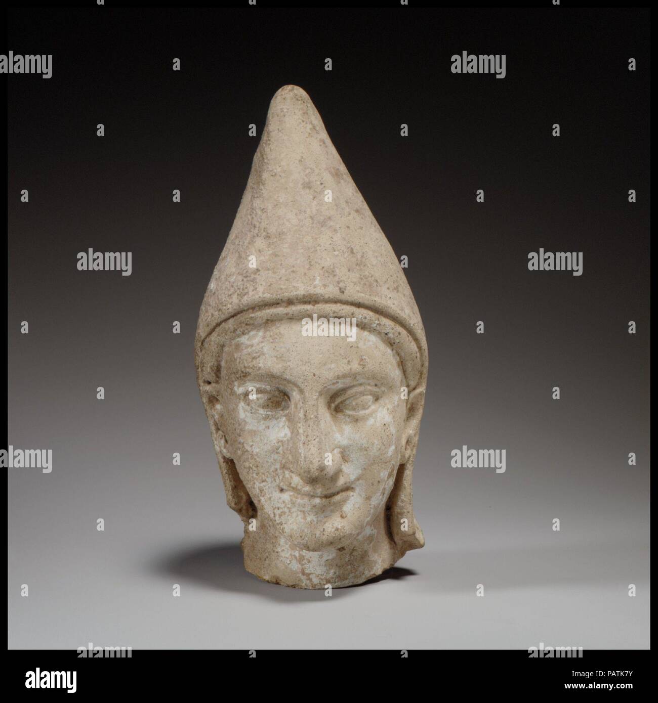 Chef d'un des jeunes. La culture chypriote :. Dimensions : H. 5 5/8 in. (14,3 cm). Date : ca. 600-480 av. J.-C.. Le moule-chef a un visage ovale, souriant légèrement des lèvres, de petits yeux, et un grand nez. Musée : Metropolitan Museum of Art, New York, USA. Banque D'Images