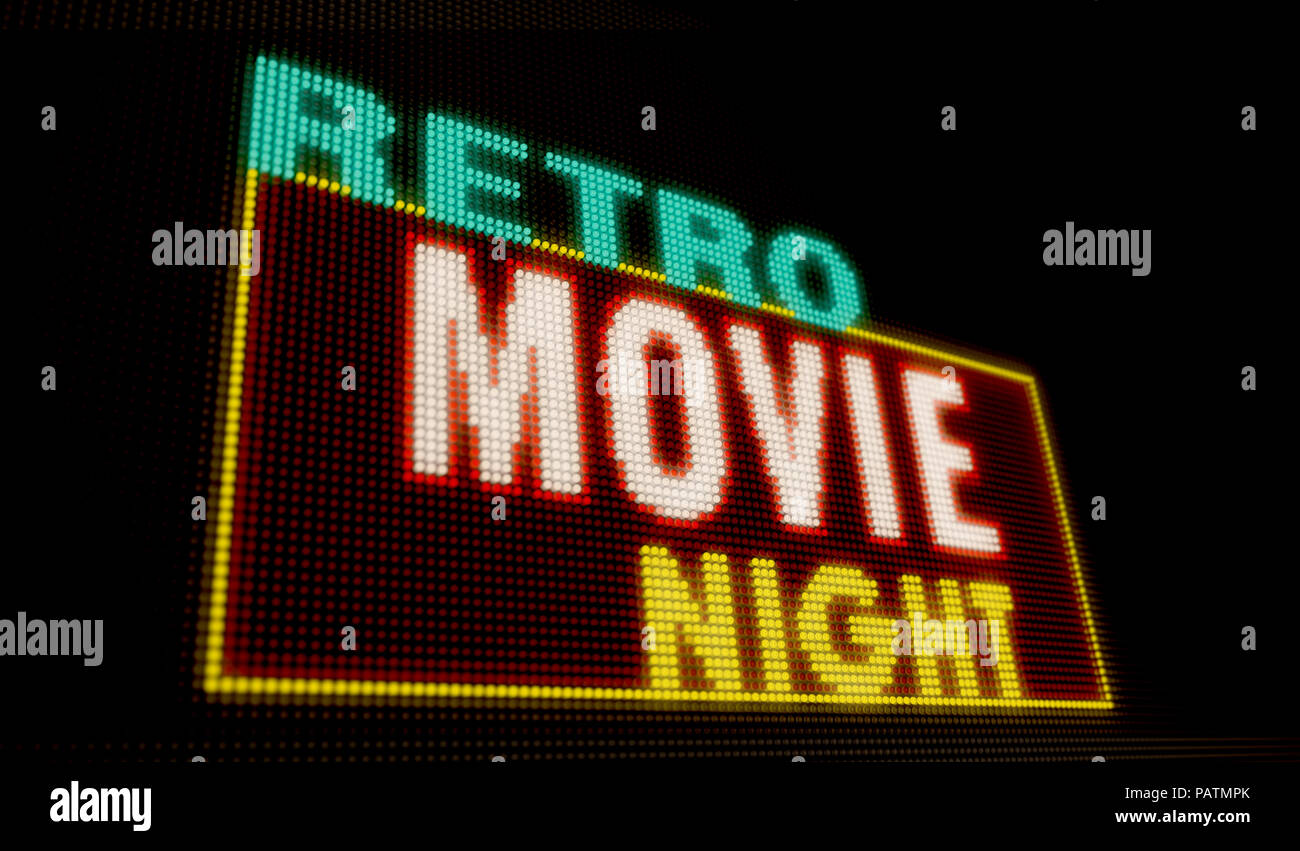 Film rétro éclairé de nuit intro lettres sur grand écran néon avec de gros pixels. La lumière vive du texte sur l'affichage des ampoules. La publicité de l'événement de divertissement Banque D'Images
