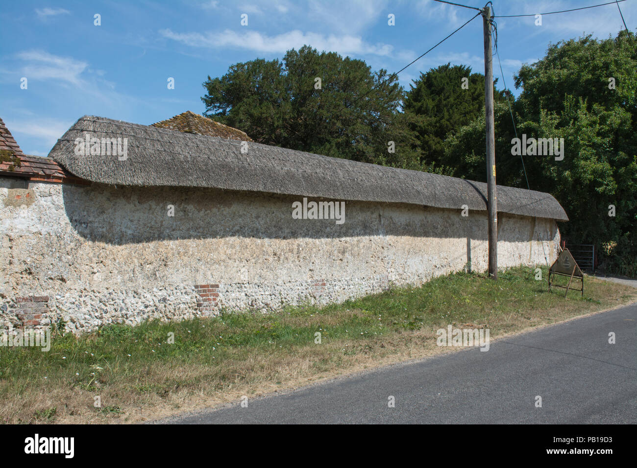 Mur de chaume près de la route dans le Hampshire village de Broughton, UK Banque D'Images