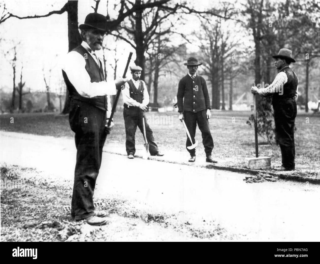 1014 Hommes faisant des travaux extérieurs à Queen's Park Banque D'Images