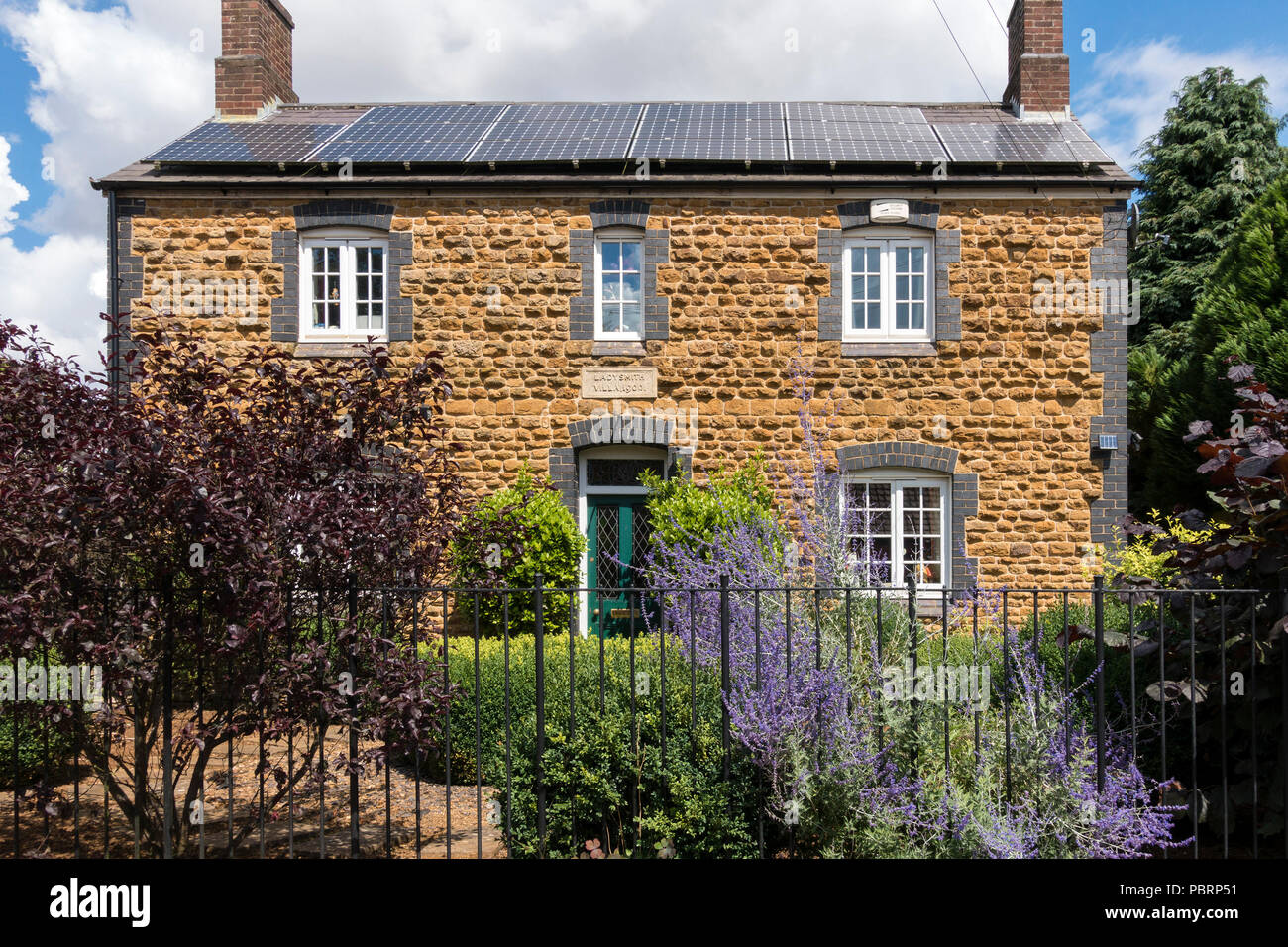Front elevation, Ladysmith, Villa, vieille brique bleu et jaune maison construite en pierre avec des panneaux solaires sur toit, C1900, Somerby, Leicestershire, England, UK Banque D'Images
