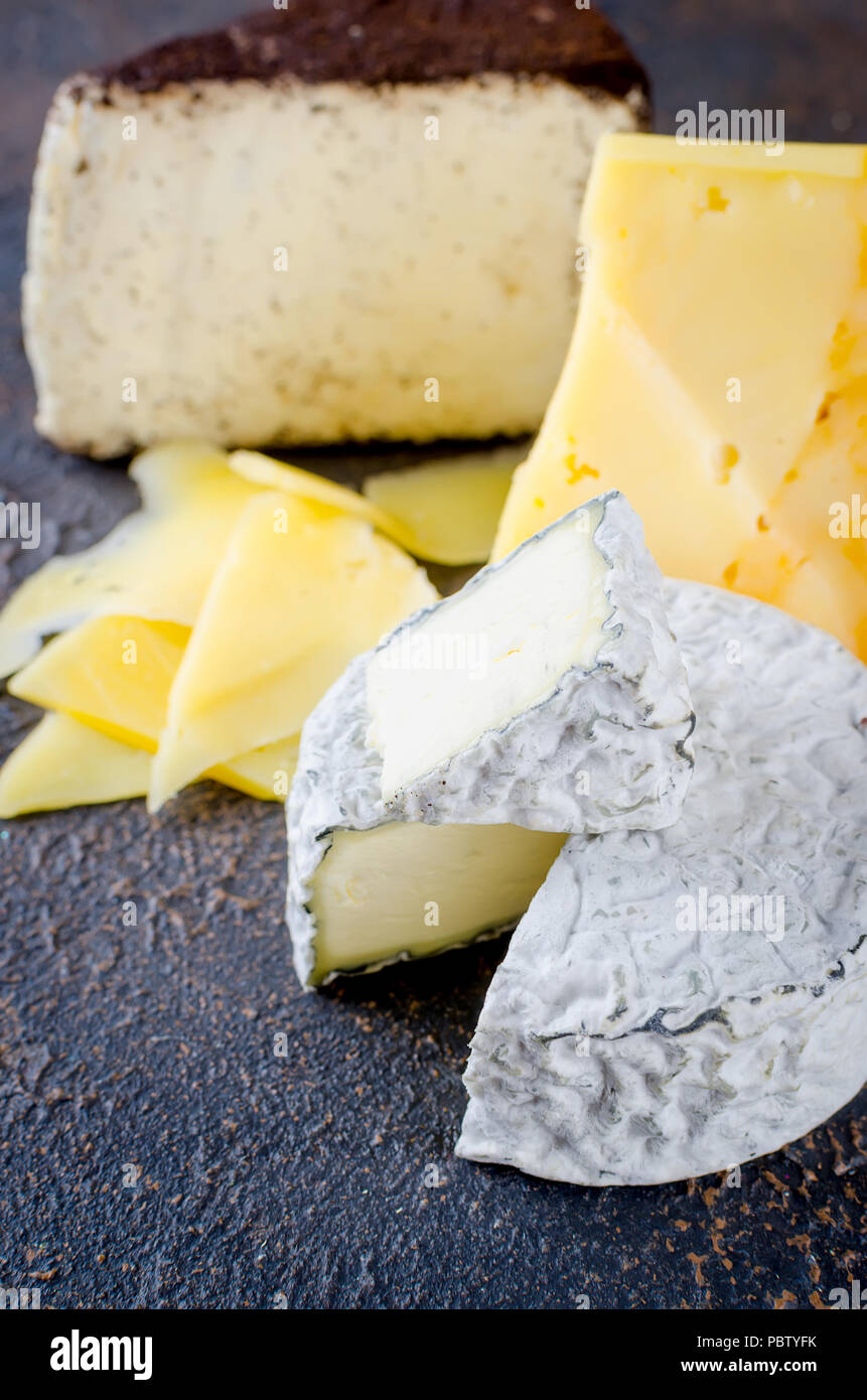 Différents types de fromages sur le plateau, assiette de fromage à partir d'un morceau de fromage à pâte dure, de fines tranches de fromage bleu, tête ronde Banque D'Images