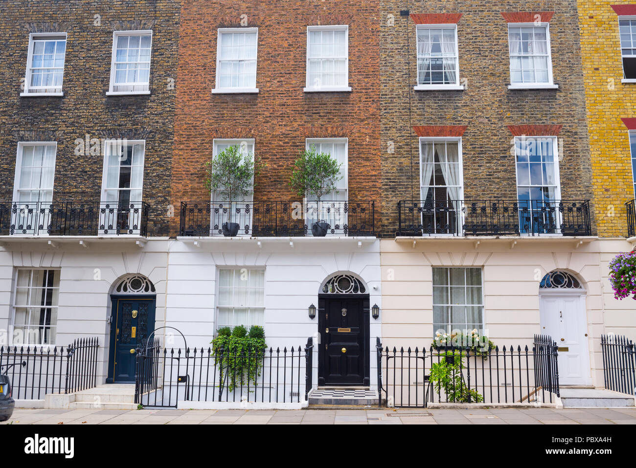 Façade de maisons de ville de résidence géorgienne fait en jaune et rouge brique dans un quartier résidentiel de luxe de l'ouest de Londres. Banque D'Images