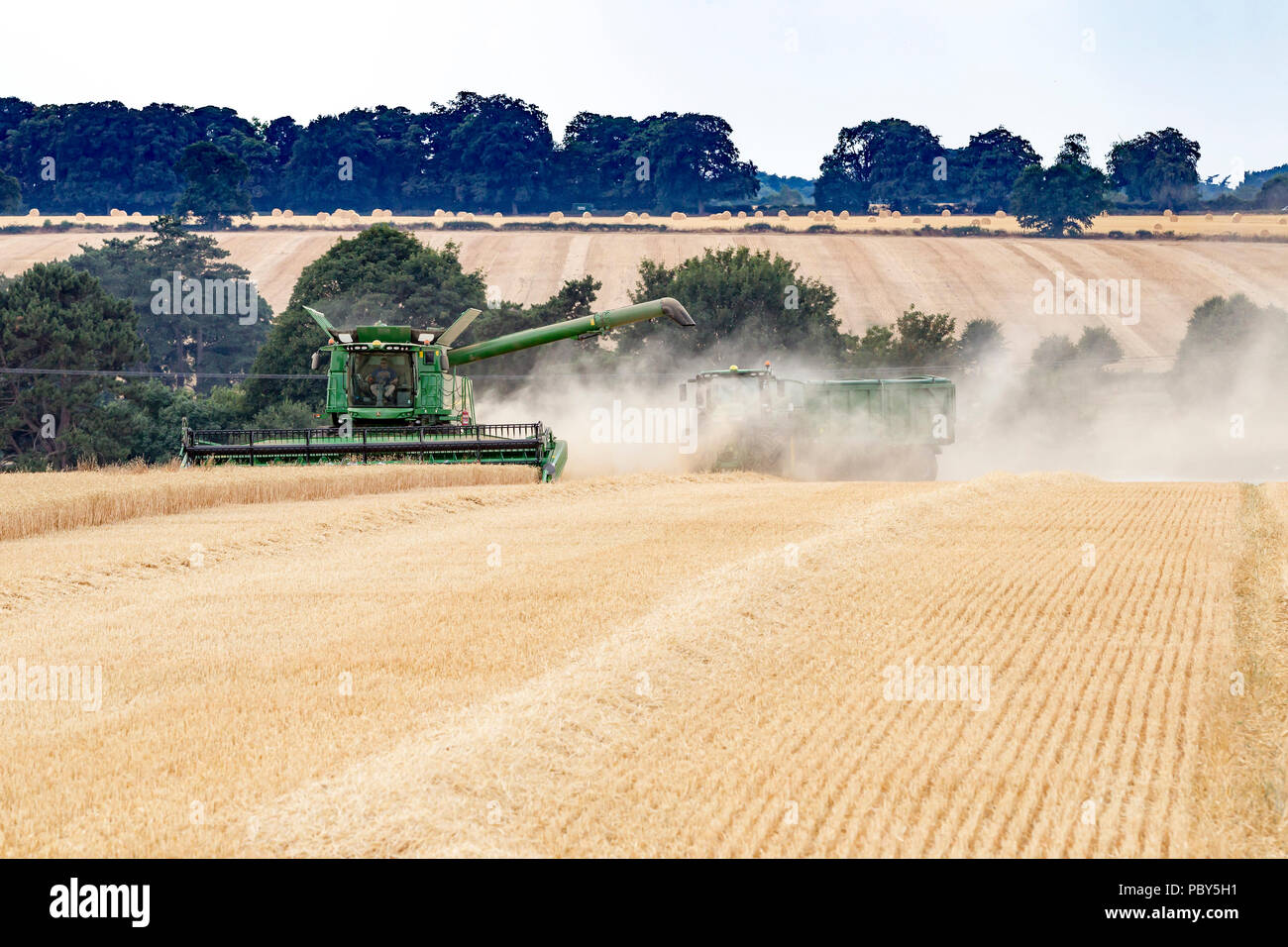 Earls Barton, Northamptonshire, Angleterre. 26 juillet, 2018. Un champ off Earls Barton Road avec un John Deere HillMaster S785i moissonneuse-batteuse, rendant le plus Banque D'Images