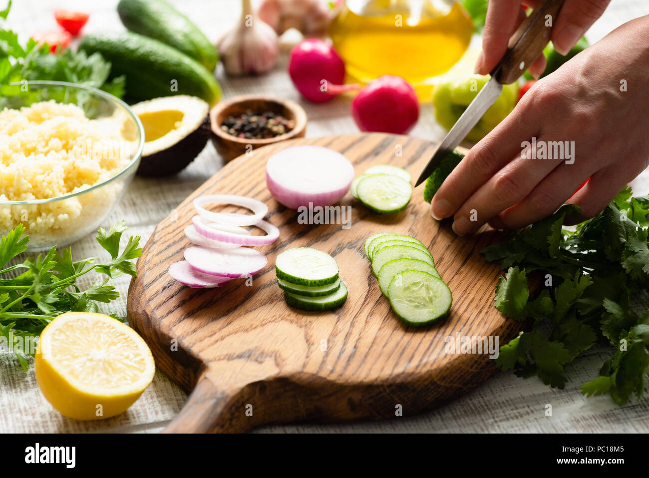 Coupe féminine des légumes frais pour la salade. Arrière-plan de cuisson. Préparation de la salade fraîche Banque D'Images