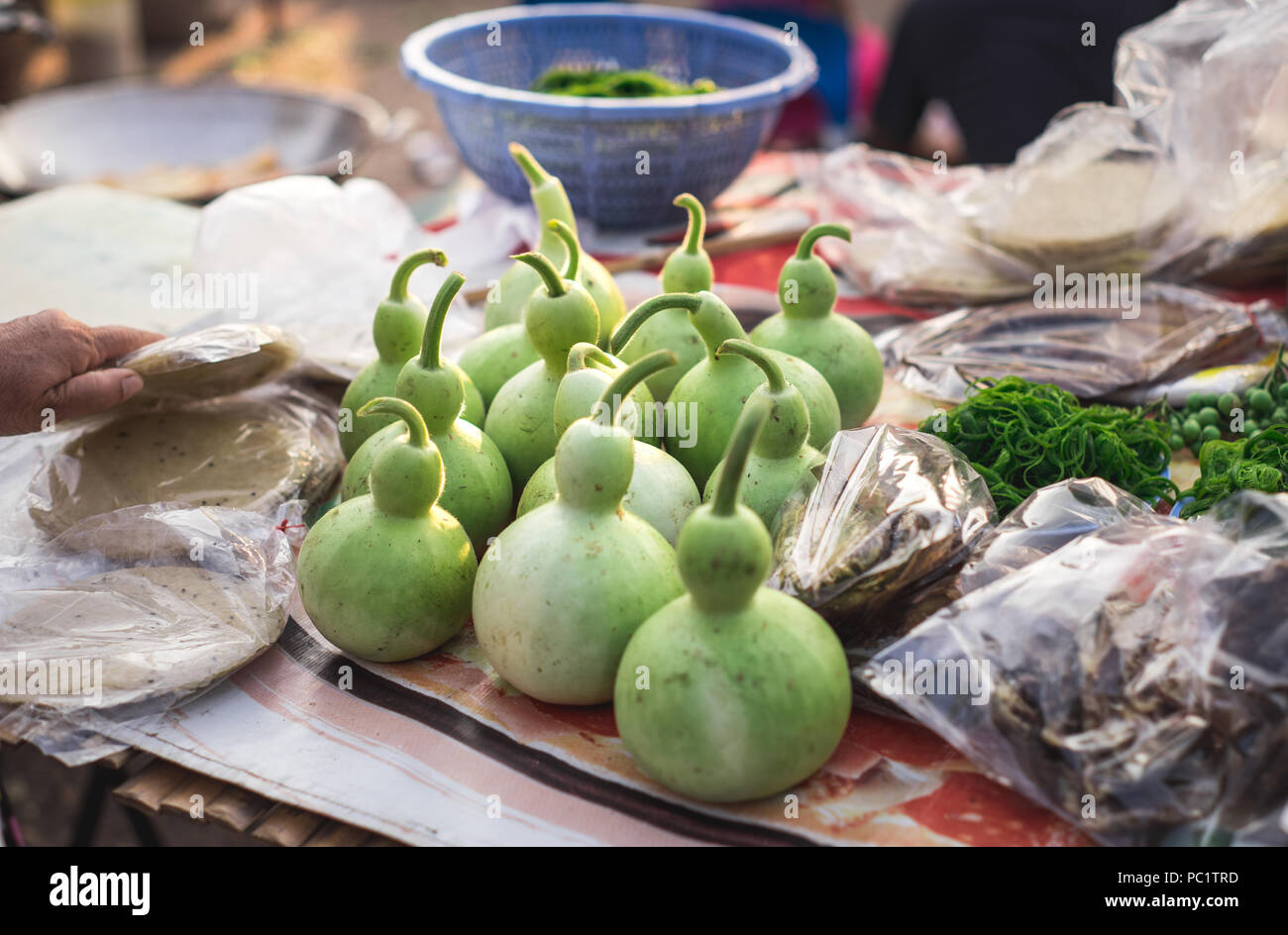 La bouteille gourdes sont vendus sur une table avec d'autres aliments au marché intérieur Banque D'Images