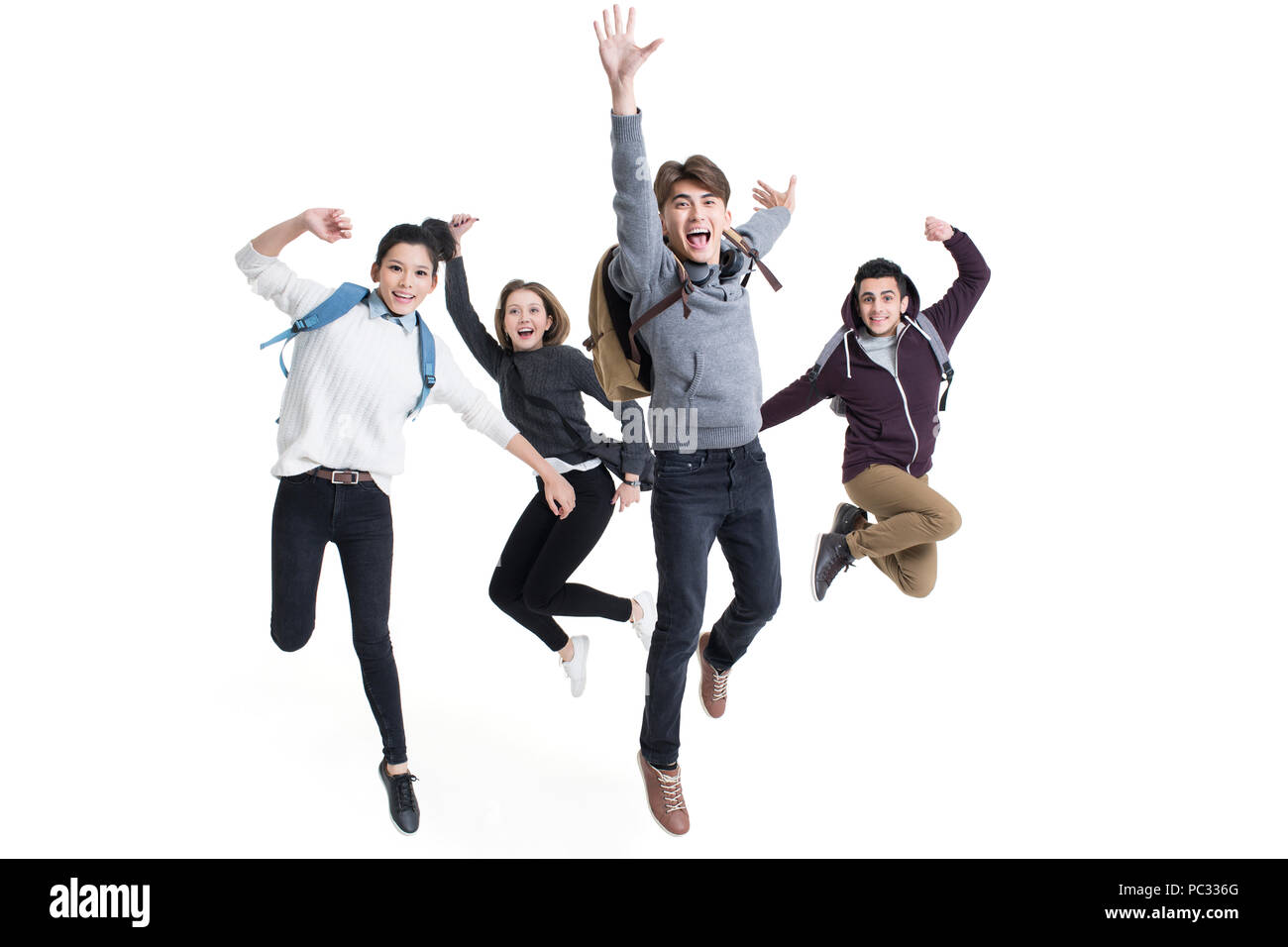 Les étudiants à l'étranger joyeux sautant Banque D'Images