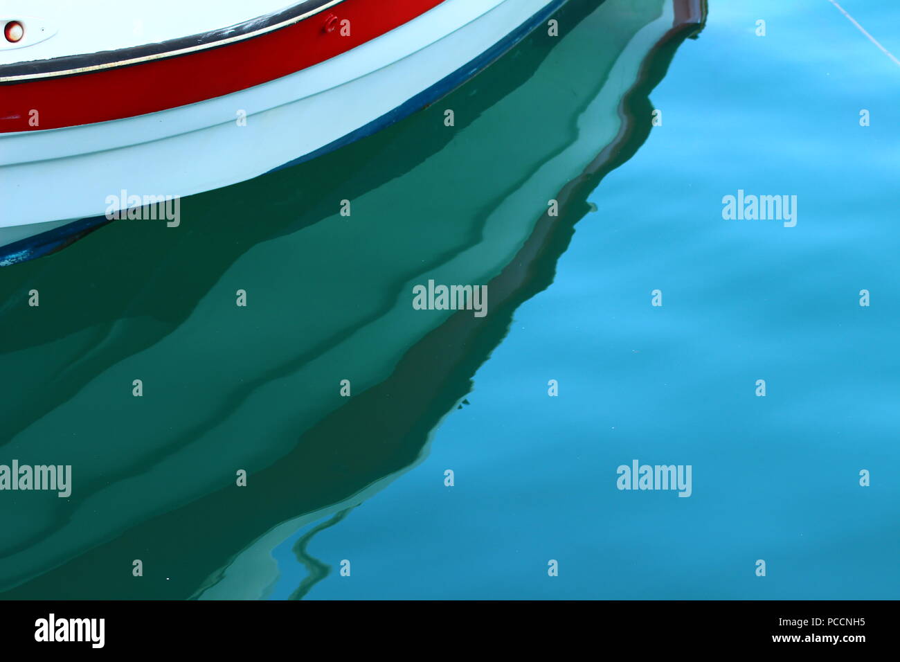 Une réflexion d'un bateau dans l'eau de mer sur le port de Limenas Thassos, Grèce Banque D'Images