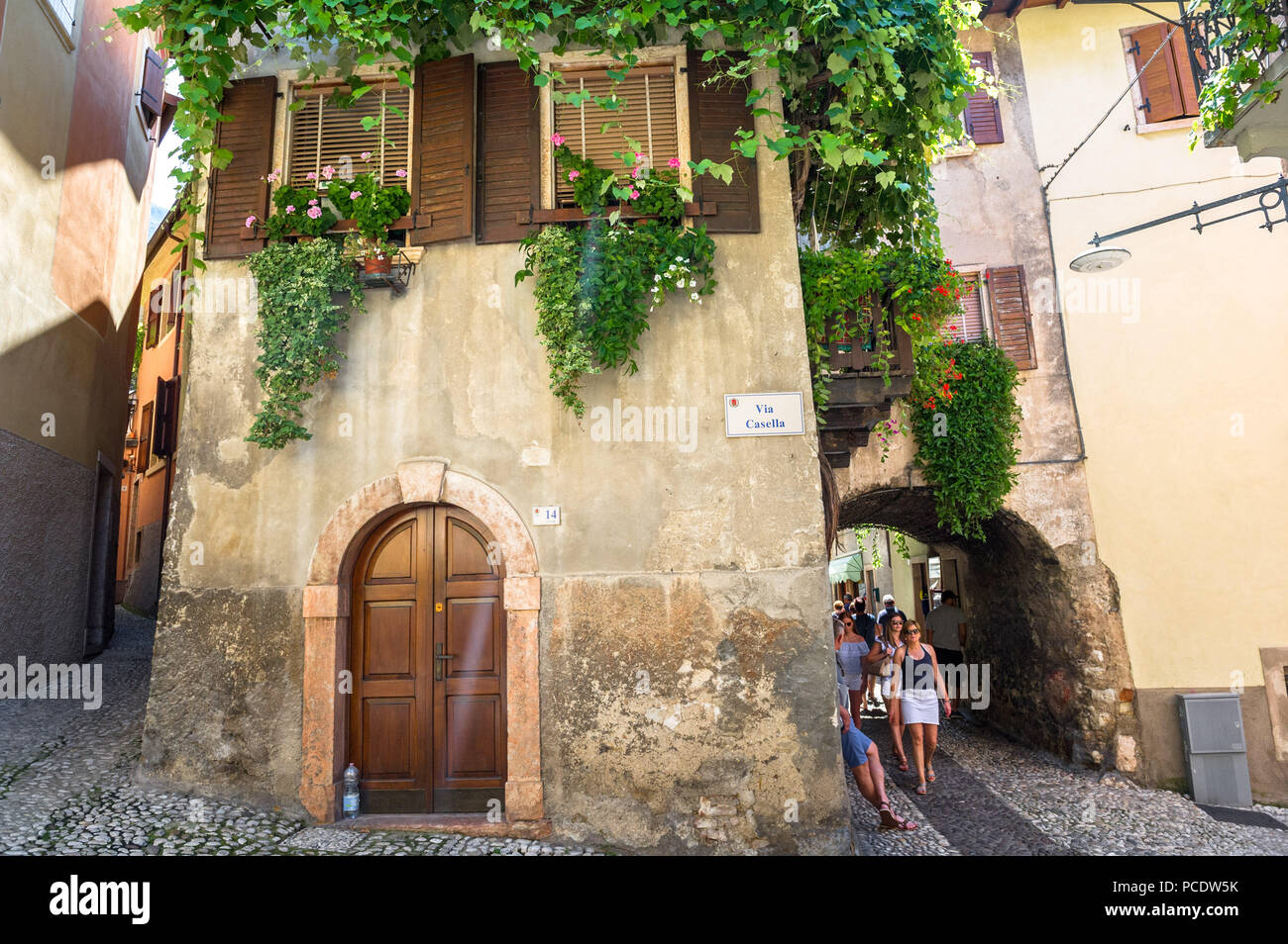 Les touristes et les acheteurs à marcher le long des ruelles et passages de la vieille ville de Malcesine, Italie. Banque D'Images