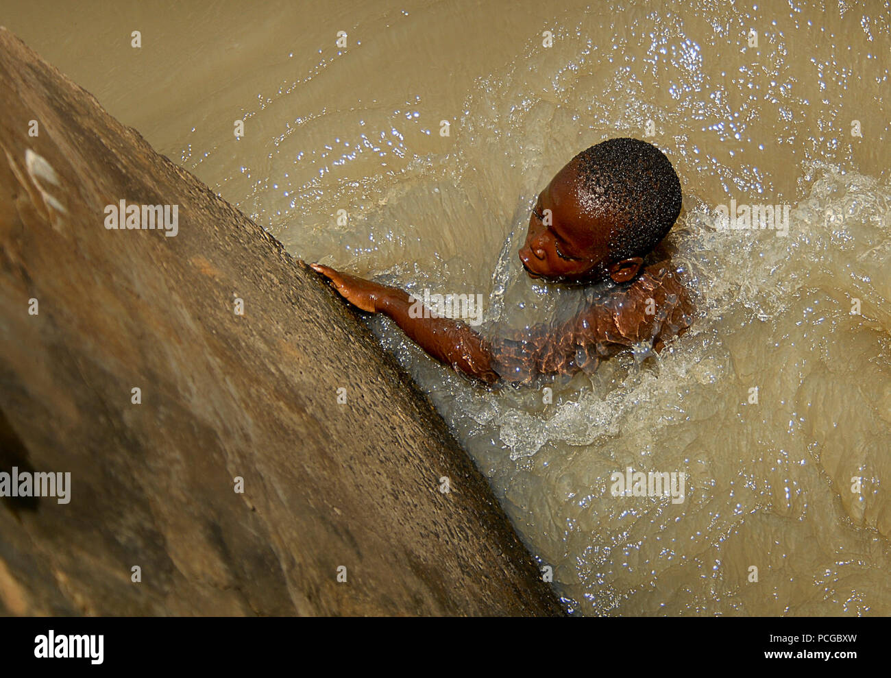 Un jeune garçon est considéré comme de la natation les vétérinaires du Gfim - Corne de l'Afrique (CJTF-HOA) passent à un programme d'action civile vétérinaire (VETCAP) mission à Gula, Ouganda, le 12 septembre 2008. CJTF-HOA effectue couramment des VETCAPS pour favoriser de meilleures relations avec ses partenaires africains. Banque D'Images
