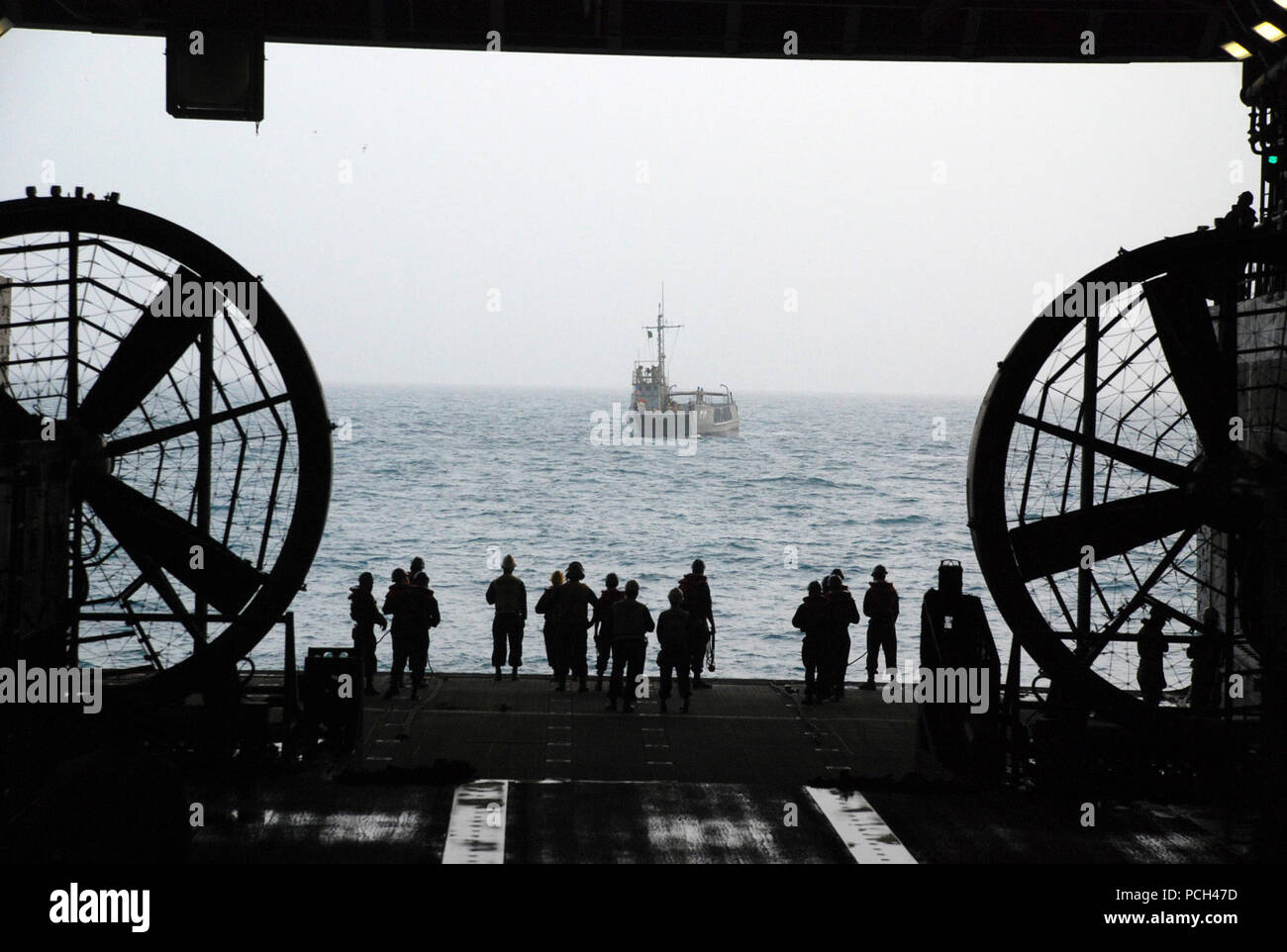 U.S. 5ÈME ZONE DE RESPONSABILITÉ DE LA FLOTTE (janv. 8, 2013) marins attendre pour effectuer un mariage porte arrière avec un utilitaire de débarquement dans le pont du coffre de la cale de transport amphibie USS Green Bay (LPD 20). Green Bay fait partie de la groupe amphibie de Peleliu, avec la 15e unité expéditionnaire de Marines embarqués, déployé des opérations de sécurité maritime et les efforts de coopération en matière de sécurité dans le théâtre dans la 5e Flotte des États-Unis zone de responsabilité. Banque D'Images