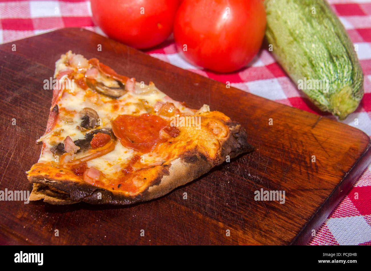Pizza artisanale sur une plaque de bois Banque D'Images Pizza artisanale sur une plaque de bois Banque D'Images