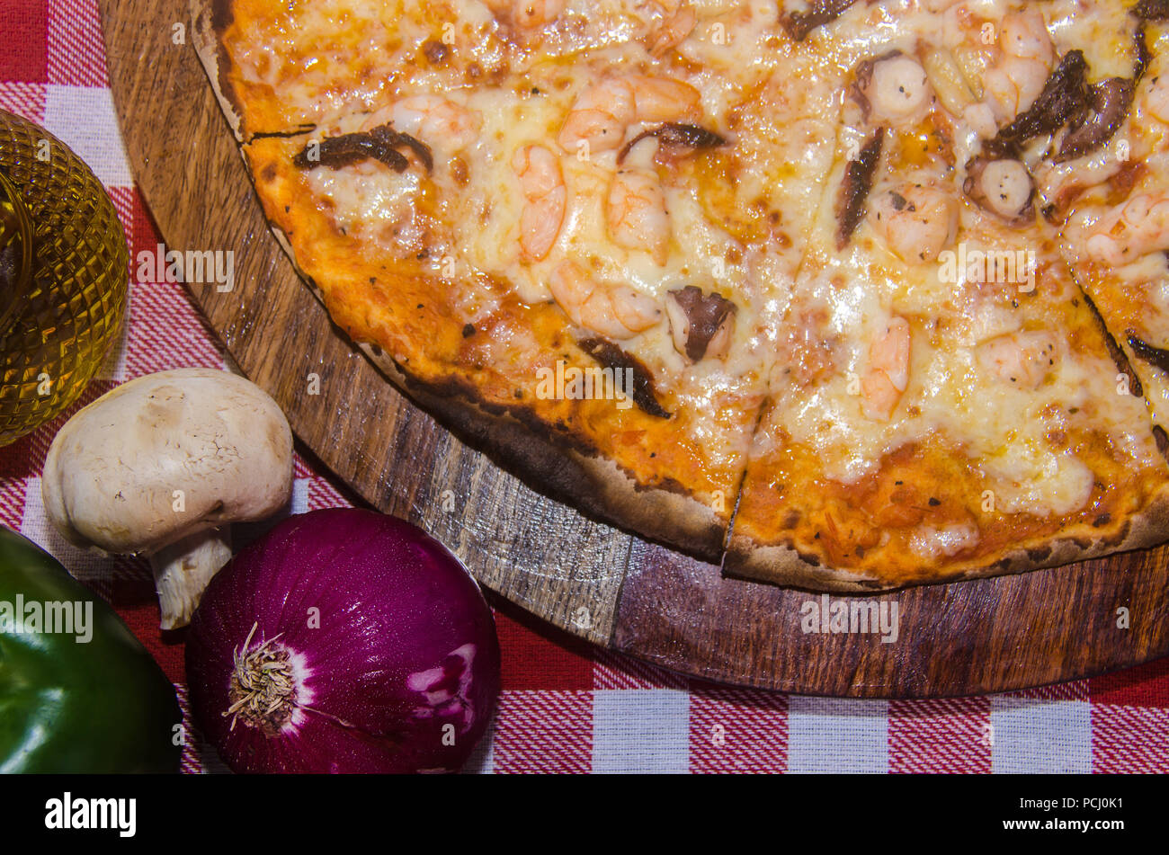 Pizza artisanale sur une plaque de bois Banque D'Images Pizza artisanale sur une plaque de bois Banque D'Images