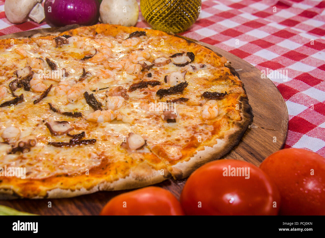 Pizza artisanale sur une plaque de bois Banque D'Images Pizza artisanale sur une plaque de bois Banque D'Images