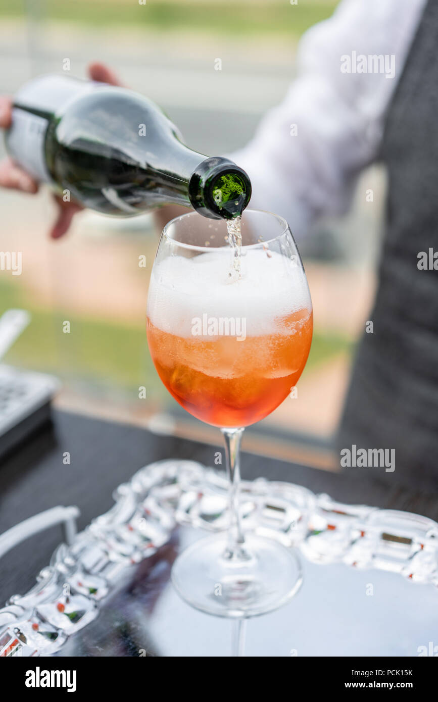 Barman cocktail Aperol spritz fait. Le verre embué, selective focus. Boisson alcoolisée basé sur comptoir bar avec des cubes de glace et d'oranges. outdoor party Banque D'Images