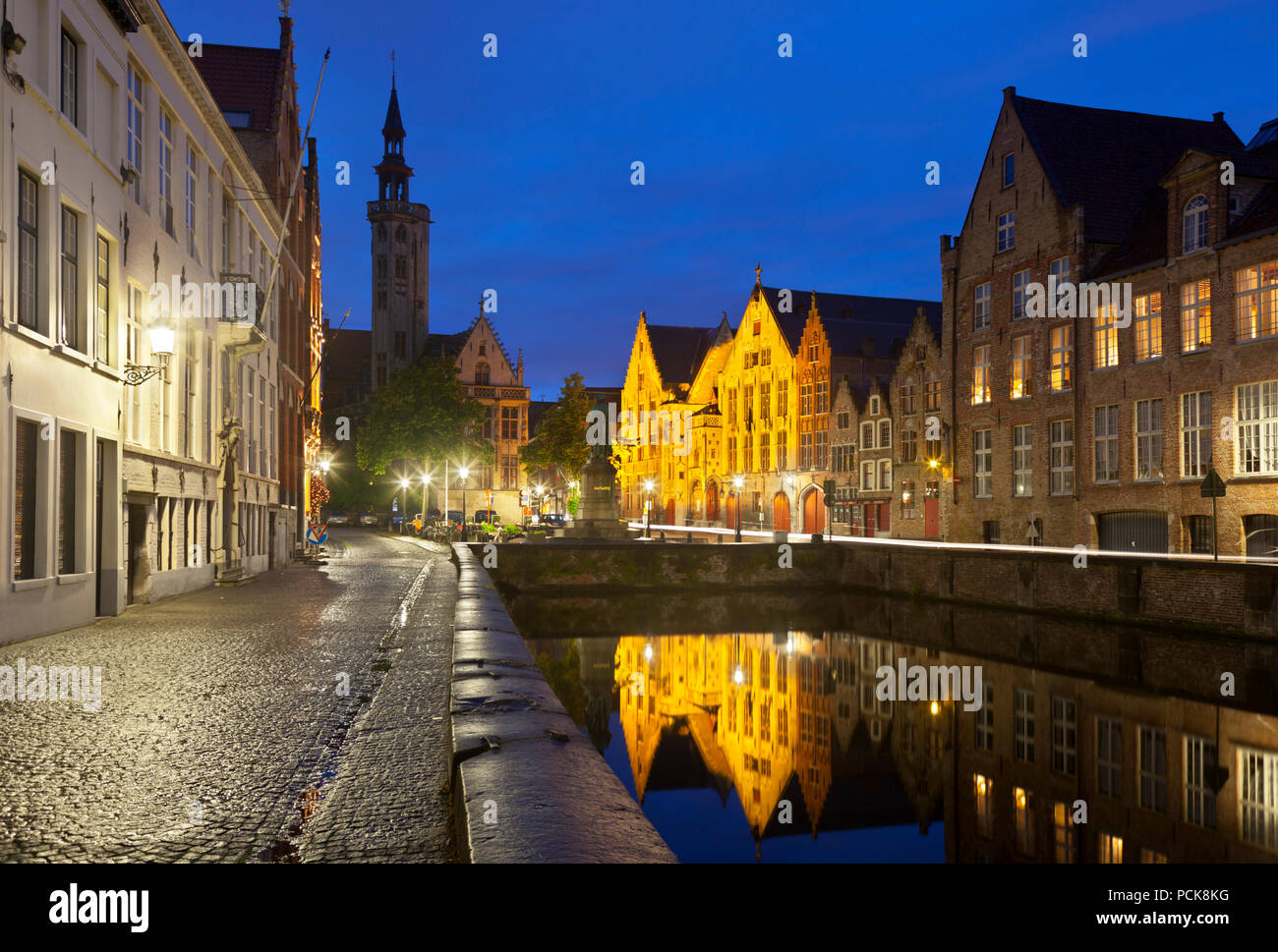 Jan van Eyckplein et Poortersloge à côté de la vieille maison illuminée sans frais à Bruges dans la nuit. Banque D'Images