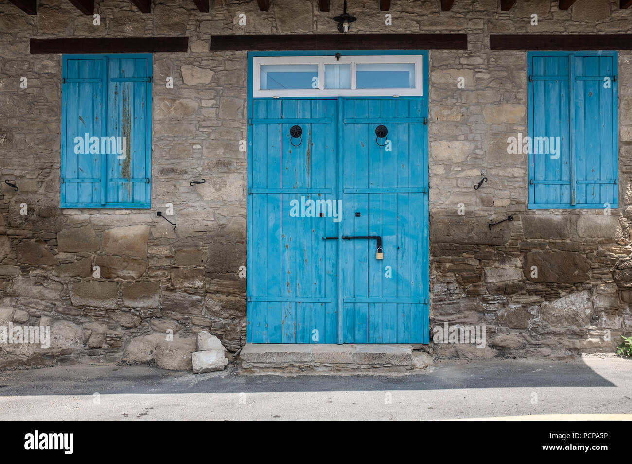 Portes bleues avec un visage sur Maison dans le village pittoresque de Tochni, dans la région de Larnaca Chypre Banque D'Images