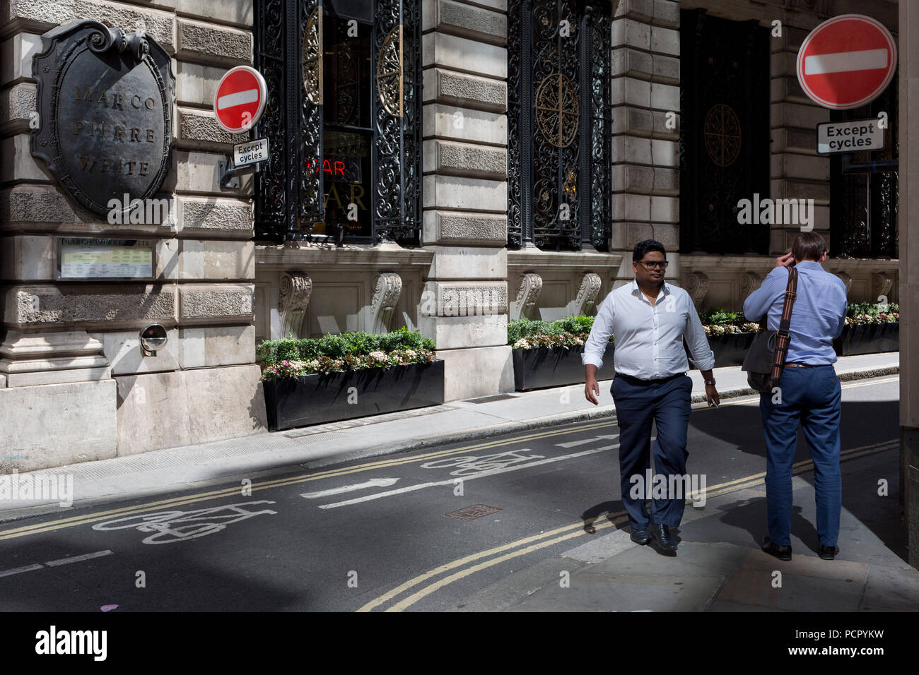 Deux hommes de se croiser sur la rue Finch, un étroit couloir de l'époque médiévale dans la ville de Londres, la capitale historique du quartier financier, le 2 août 2018, à Londres, en Angleterre. Banque D'Images