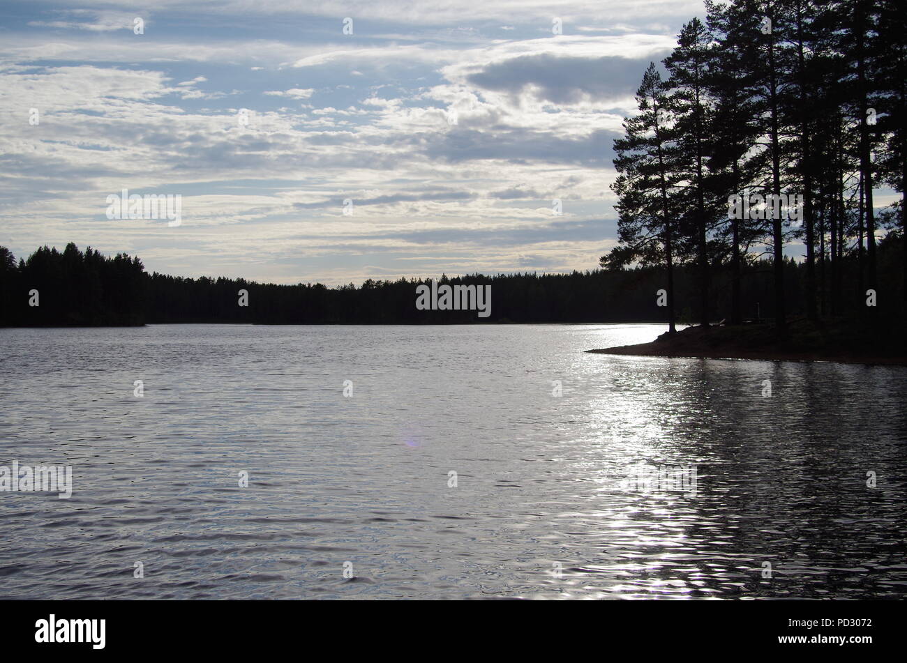 Le soleil se couche sur un lac calme en Dalécarlie Banque D'Images