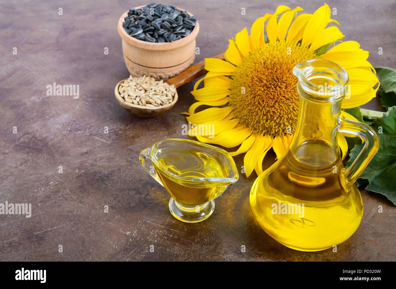 L'huile organique d'or dans un petit pot en verre, de tournesol, de graines de tournesol. L'agriculture, la production de pétrole. Bio et concept organique du produit. Banque D'Images