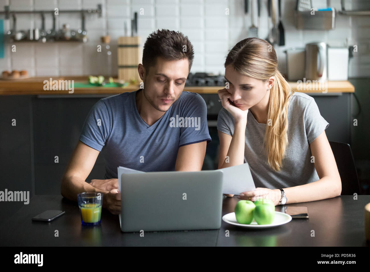 La pensée de couple famille la planification budgétaire avec ordinateur portable et documents Banque D'Images