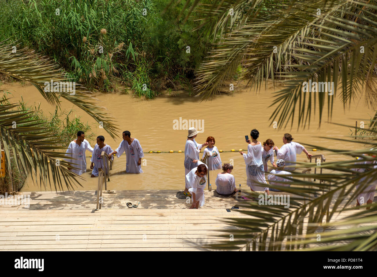 Jourdain, Israël 19 Mai 2018 : Christian pèlerins vêtus de blanc qui se fait baptiser à la même place dans le fleuve Jourdain, comme Jésus, sur la b Banque D'Images