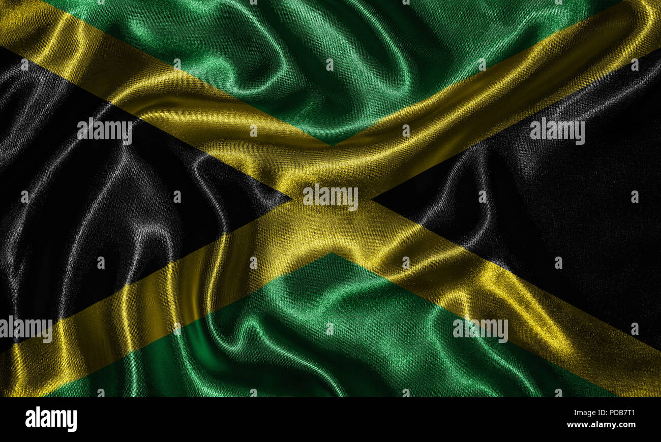 Drapeau Jamaïque - Tissu drapeau de la Jamaïque, pays de l'arrière-plan et un fond d'Waving Flag par le textile. Banque D'Images