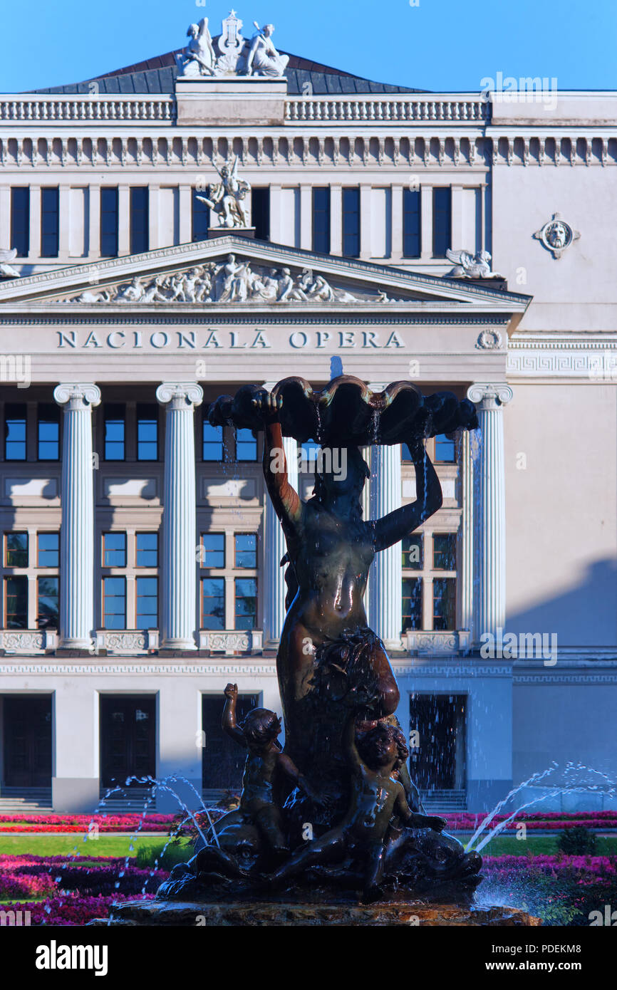Femme fontaine avec des fleurs et des anges dans le bâtiment de l'Opéra National de Lettonie à Riga avec colonnes Banque D'Images