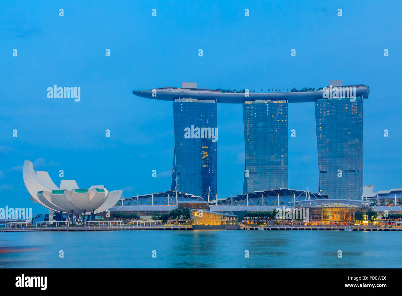 Singapour - Le 20 janvier 2014 : l'hôtel en forme de planche de surf luxueuses et Marina Bay Sands casino et lotus-inspiré Musée ArtScience avant le coucher du soleil Banque D'Images