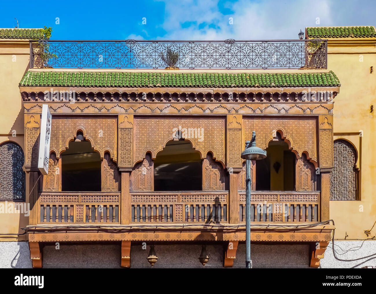 Bois sculpté orné de ferronnerie et balcon sur la façade d'un riad marocain à Marrakech, Maroc Banque D'Images