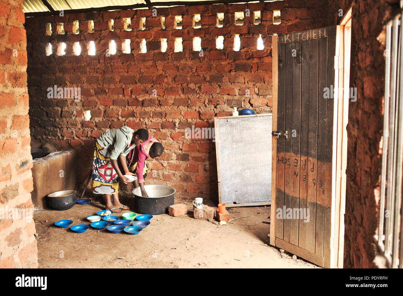 Jeune fille ougandaise est à la maison pour s'occuper de ses haricots et graines dans les régions rurales de l'Ouganda Banque D'Images