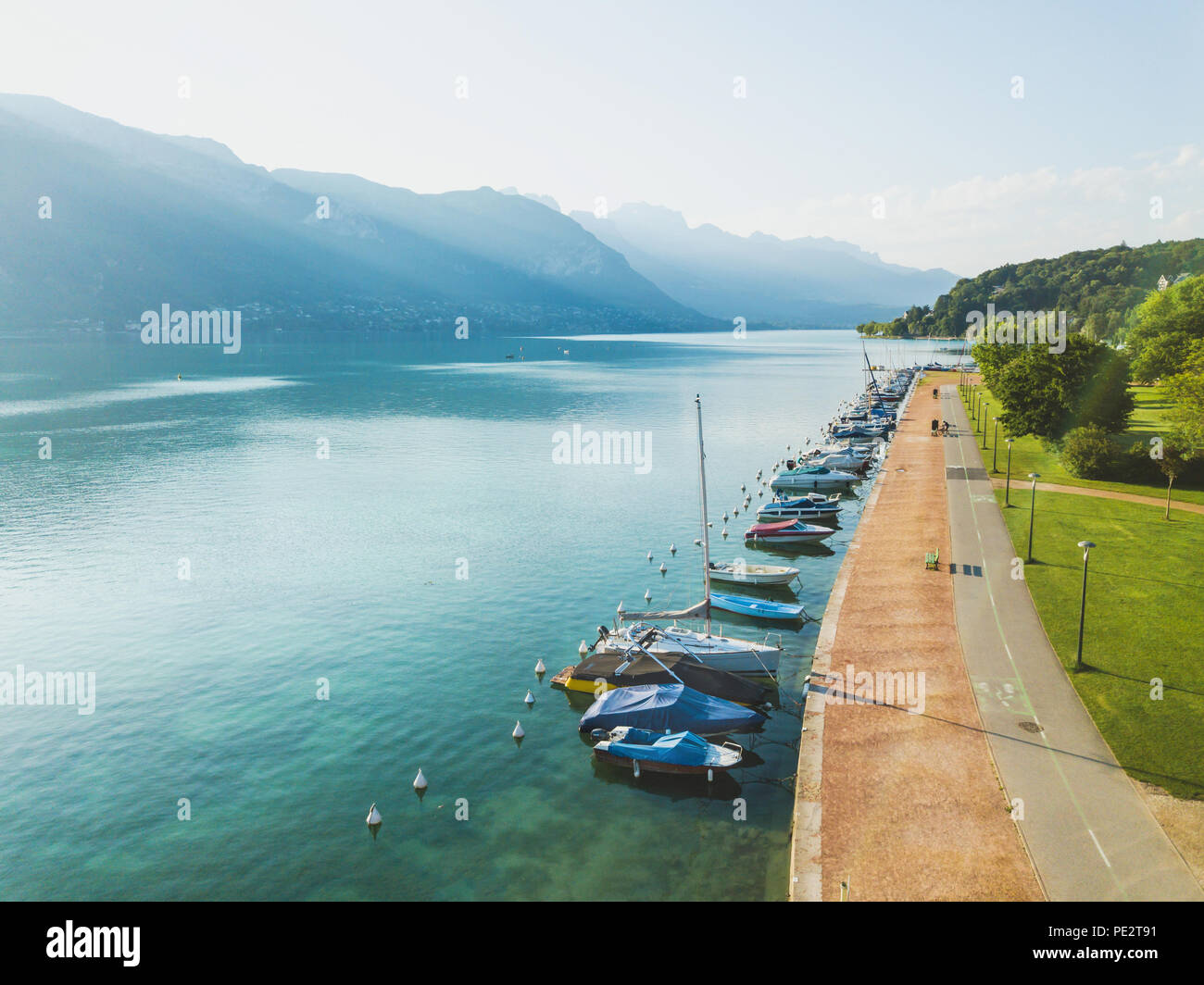 Paysage aérien du lac d'Annecy, Alpes, France, yachts et bateaux à voile à partir de ci-dessus, zone piétonne à pied près de l'eau bleu cristal Banque D'Images