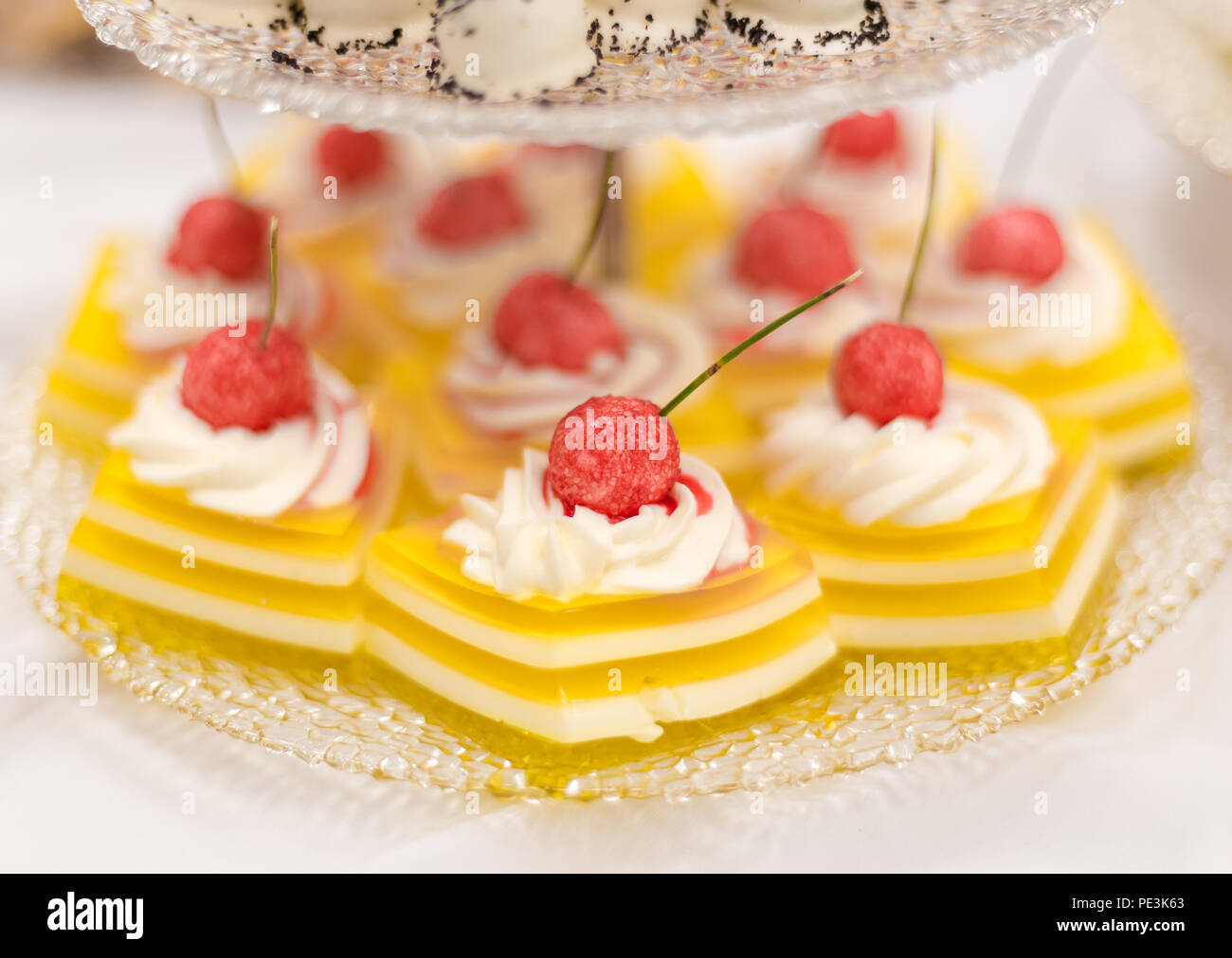 Jello citron tartelettes de crème fouettée et de framboises bonbons. Banque D'Images