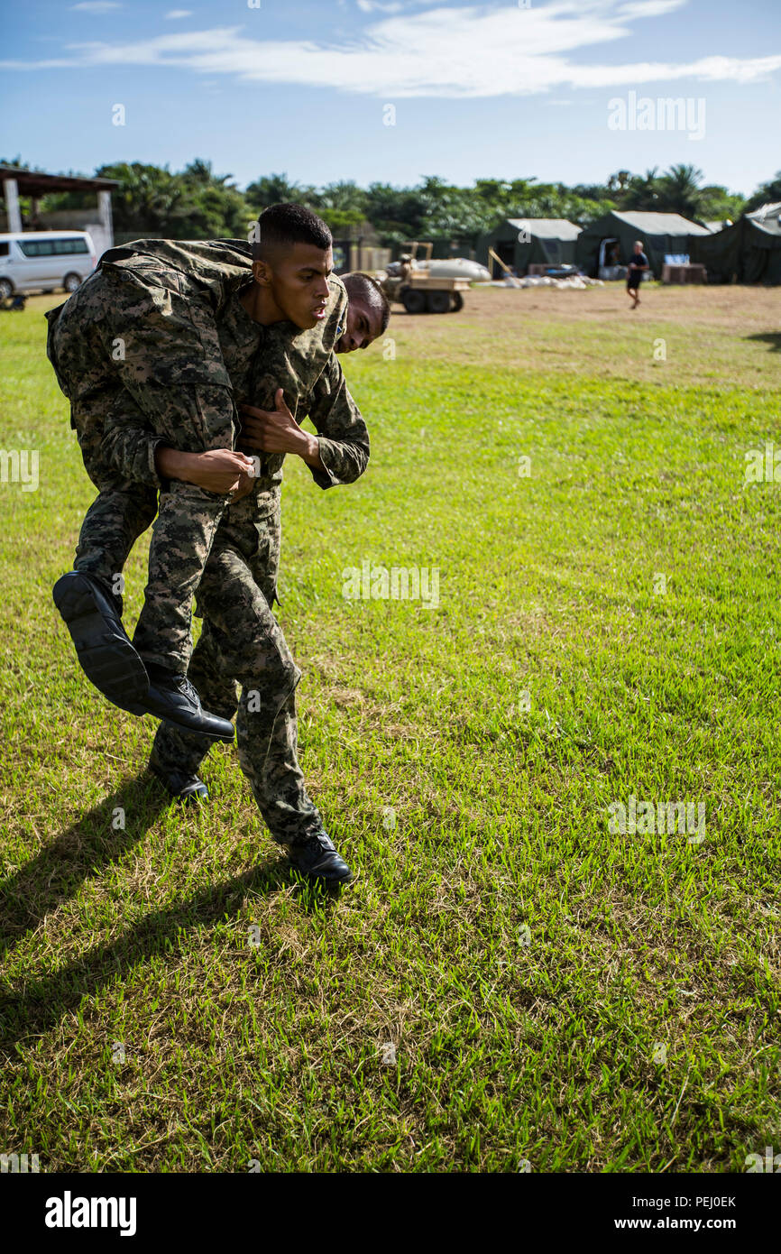 Un pompier du Honduras a un autre pendant la manoeuvre maritime sous le feu de la lutte contre la base navale de fitness test à Puerto Castilla, le Honduras, le 12 août 2015. Les Marines américains avec la coopération de sécurité maritime à des fins spéciales, Team-Honduras Groupe Force-Southern air-sol d'un suivi de commande de l'événement. SCT-Honduras est actuellement déployé dans le cadre de l'SPMAGTF-SC pour aider le Centro de Adiestramiento avec Naval la mise en œuvre d'un curriculum de formation pour créer un programme marin du Honduras. (U.S. Marine Corps Photo par le Cpl. Katelyn Hunter/relâché). Banque D'Images