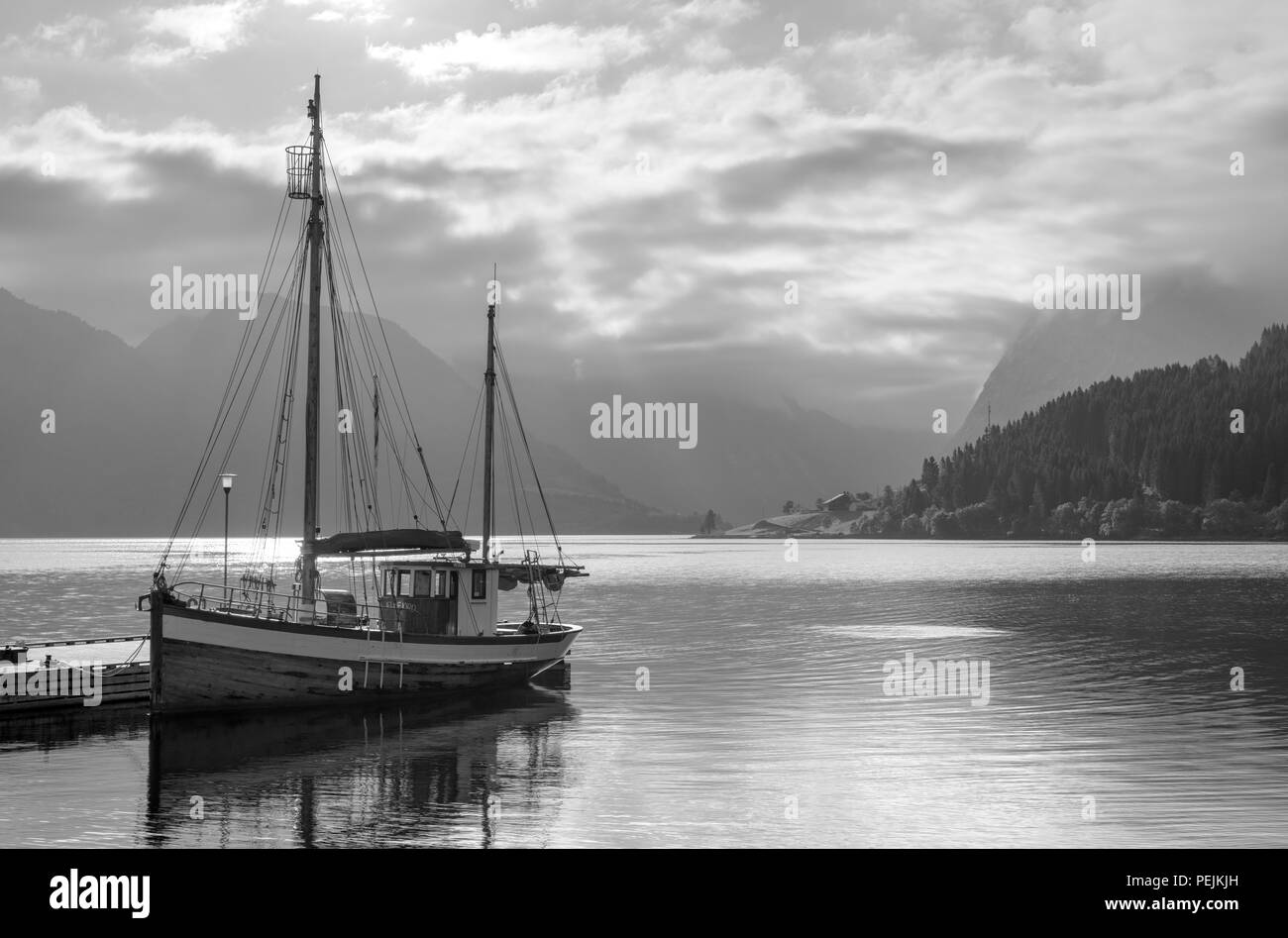 La Norvège des fjords. Bateau amarré à une jetée à l'extérieur de l'hôtel Sagafjord en début de matinée, Saebø, Hjørundfjorden, Møre og Romsdal (Norvège) Banque D'Images