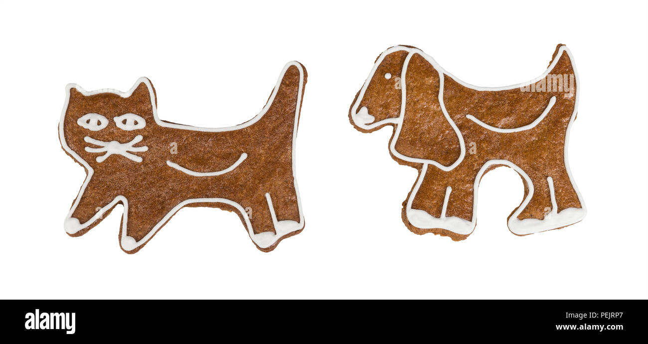 Noël mignon gingerbreads en forme de chat et de chien. Deux bonbons parfumés doux décoré par le givrage. Les confiseries traditionnelles. Idée de Noël, la fête des enfants. Banque D'Images