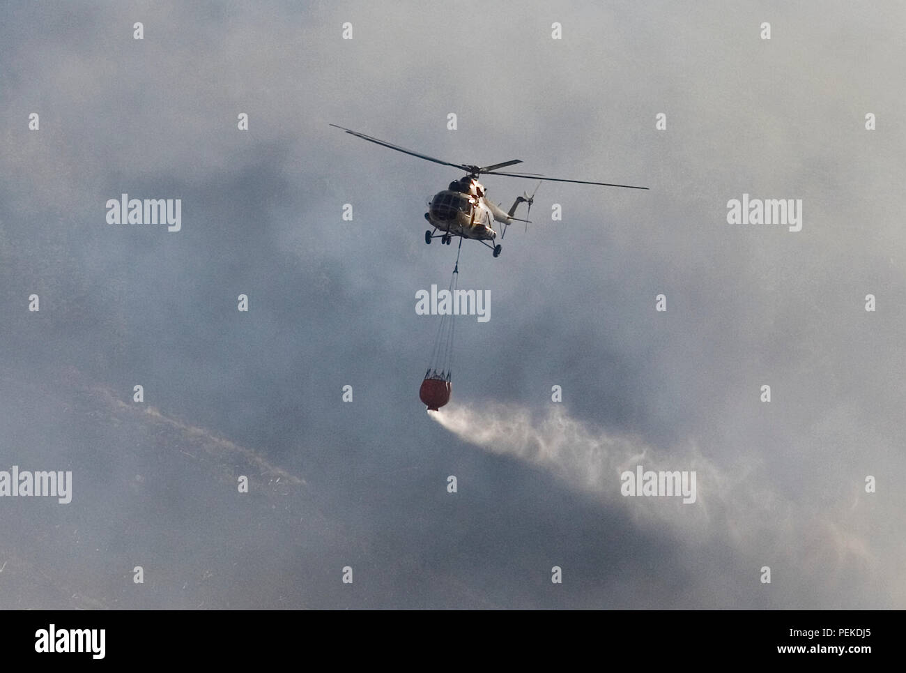 L'eau chute d'hélicoptère sur les incendies de forêt Banque D'Images