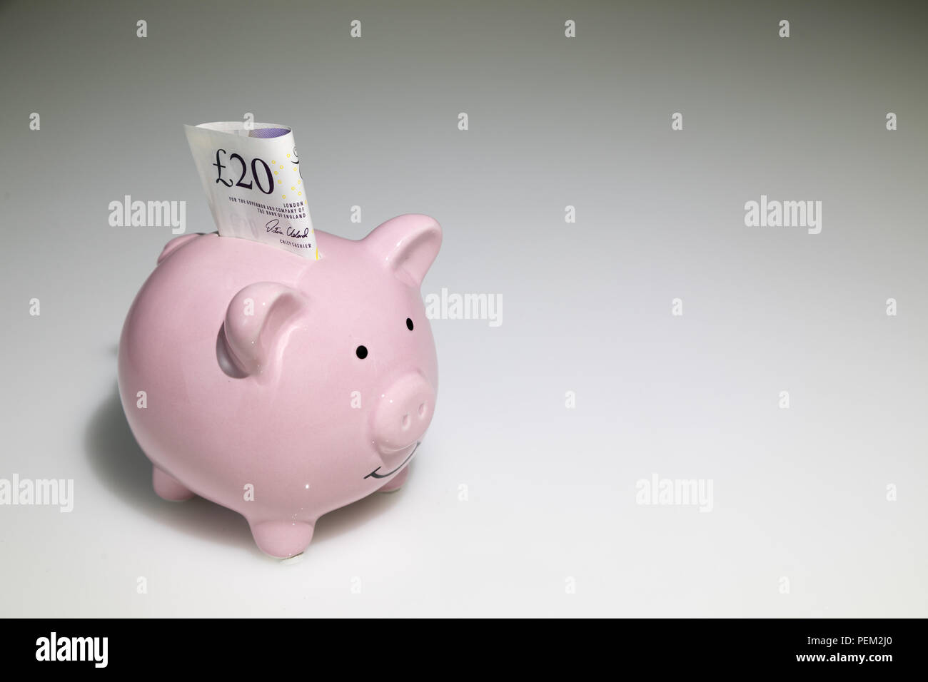 20 livre sterling dans une tirelire Banque D'Images