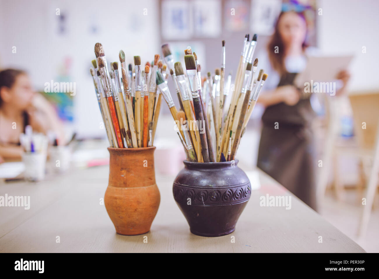 Un tas de pinceaux d'art, vases en céramique dans l'article sur la table dans l'art studio. Banque D'Images Un tas de pinceaux d'art, vases en céramique dans l'article sur la table dans l'art studio. Banque D'Images