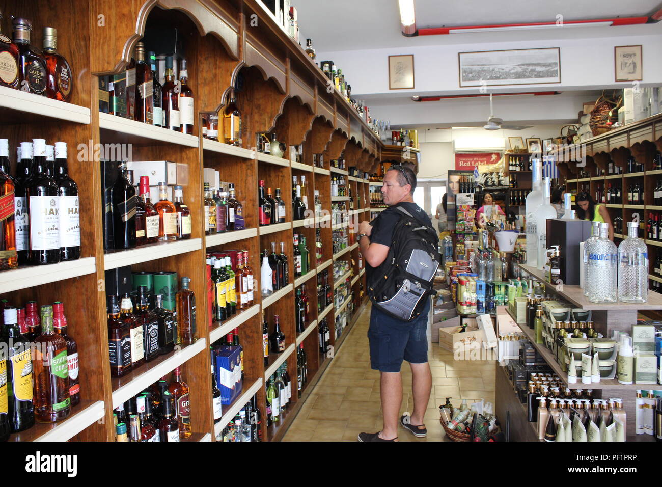 La sélection de l'homme dans un magasin d'alcool sur l'île grecque de Kalymnos Banque D'Images