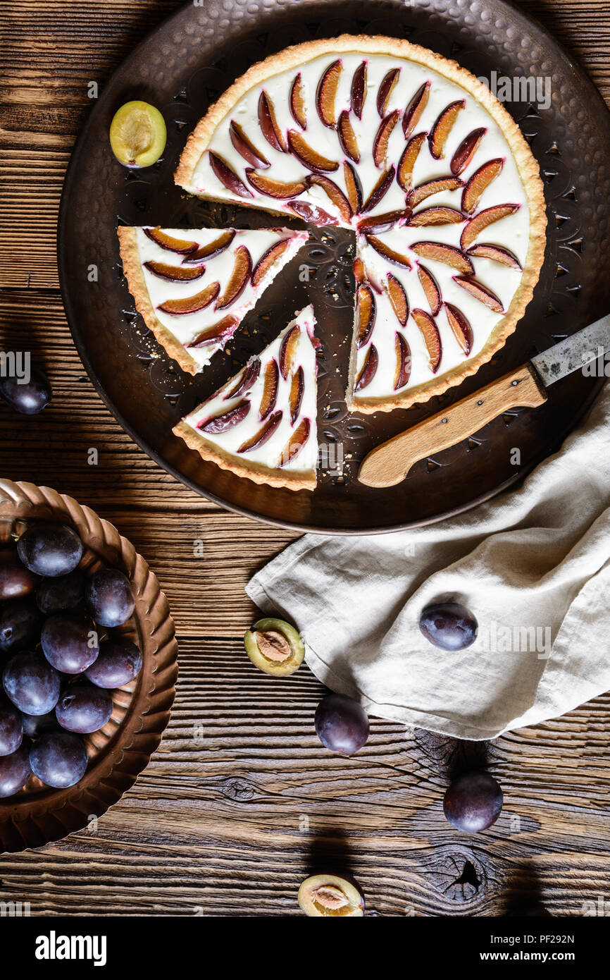 Tarte aux prunes maison remplie de tranches de fromage à la crème et la vanille Banque D'Images