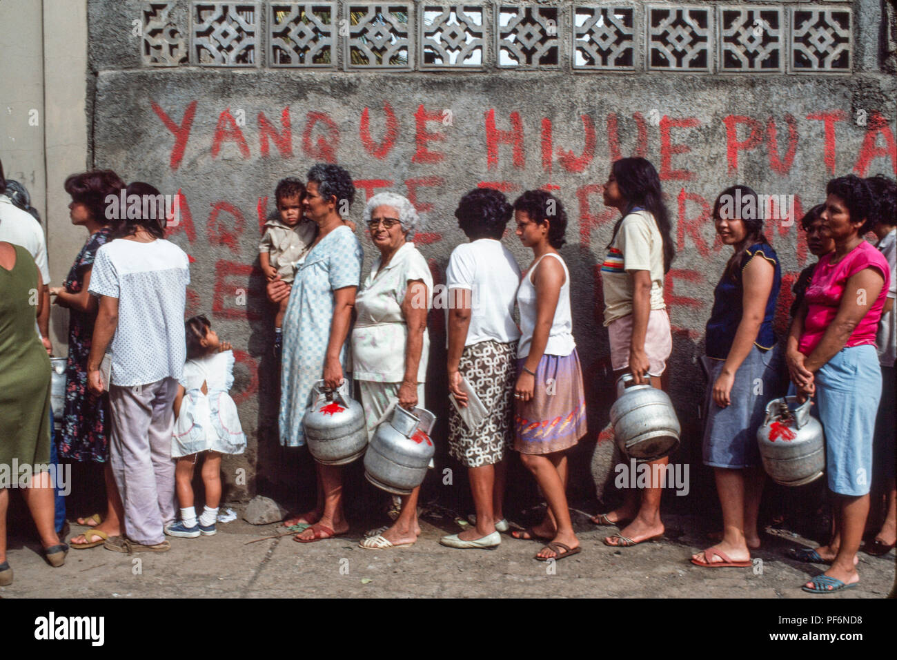 Managua, Nicaragua, juin 1986. Les gens faisant la queue pour obtenir des fournitures de gaz de cuisson calour avec leurs documents. Banque D'Images