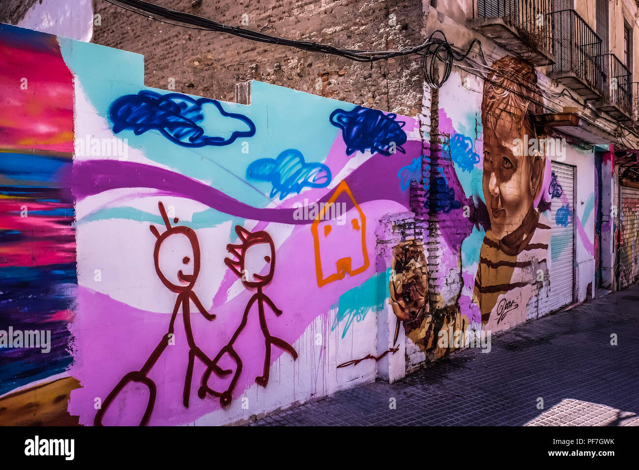 Vue paysage de l'art de la rue, un mur peint représentant un petit enfant dessin, tourné dans les rues de Malaga en Espagne, près de la Plaza de la Merced Banque D'Images