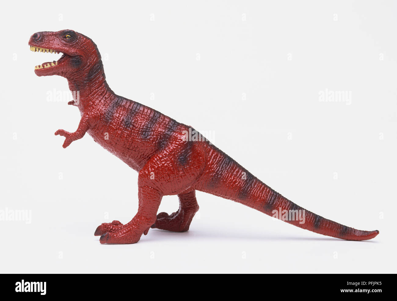 Figurine dinosaure rouge, side view Banque D'Images
