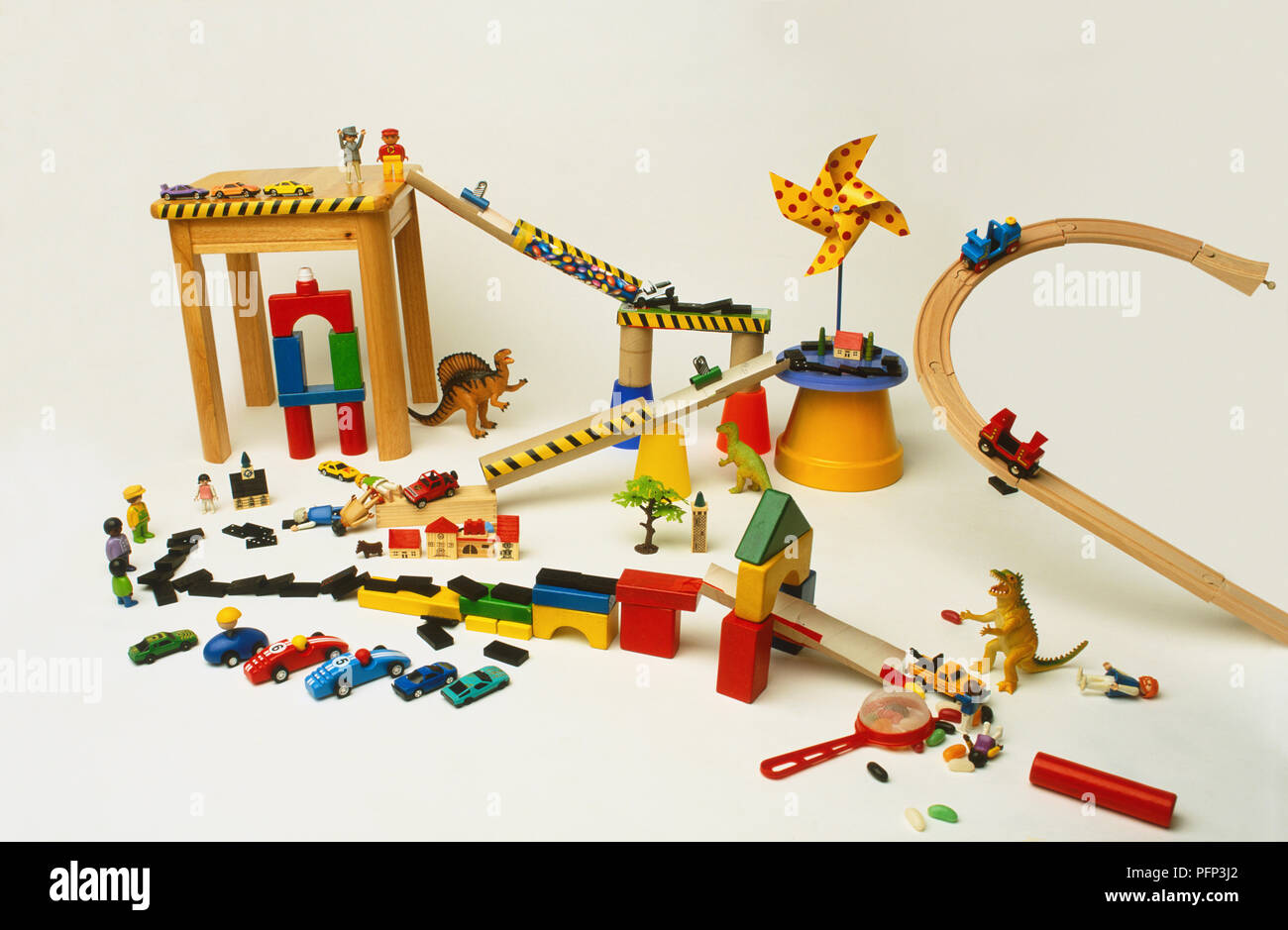 'Paysage' miniature composé de voiture en pente et les tours de pistes créées à partir de sélection de jouets colorés, blocs de construction, figurines LEGO, voitures de jouet, des dominos, des poupées. Banque D'Images