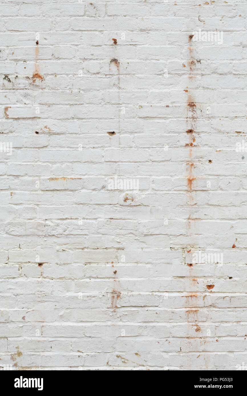 Détail de l'ancien mur de briques peint en blanc et en détresse, peeling et tachés. Idéal pour la texture grunge background Banque D'Images
