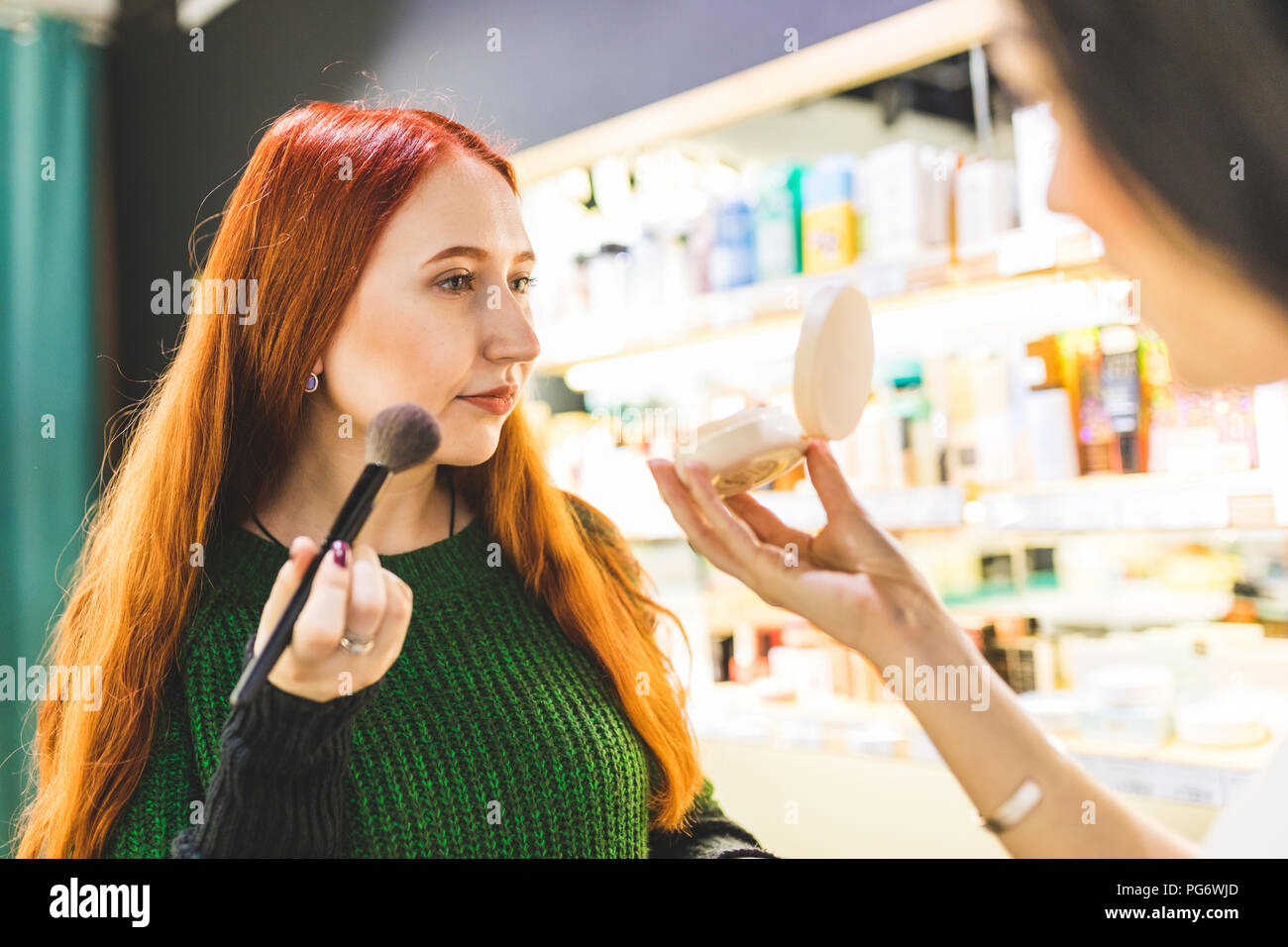 Deux femmes dans une boutique de cosmétiques d'essayer de Banque D'Images