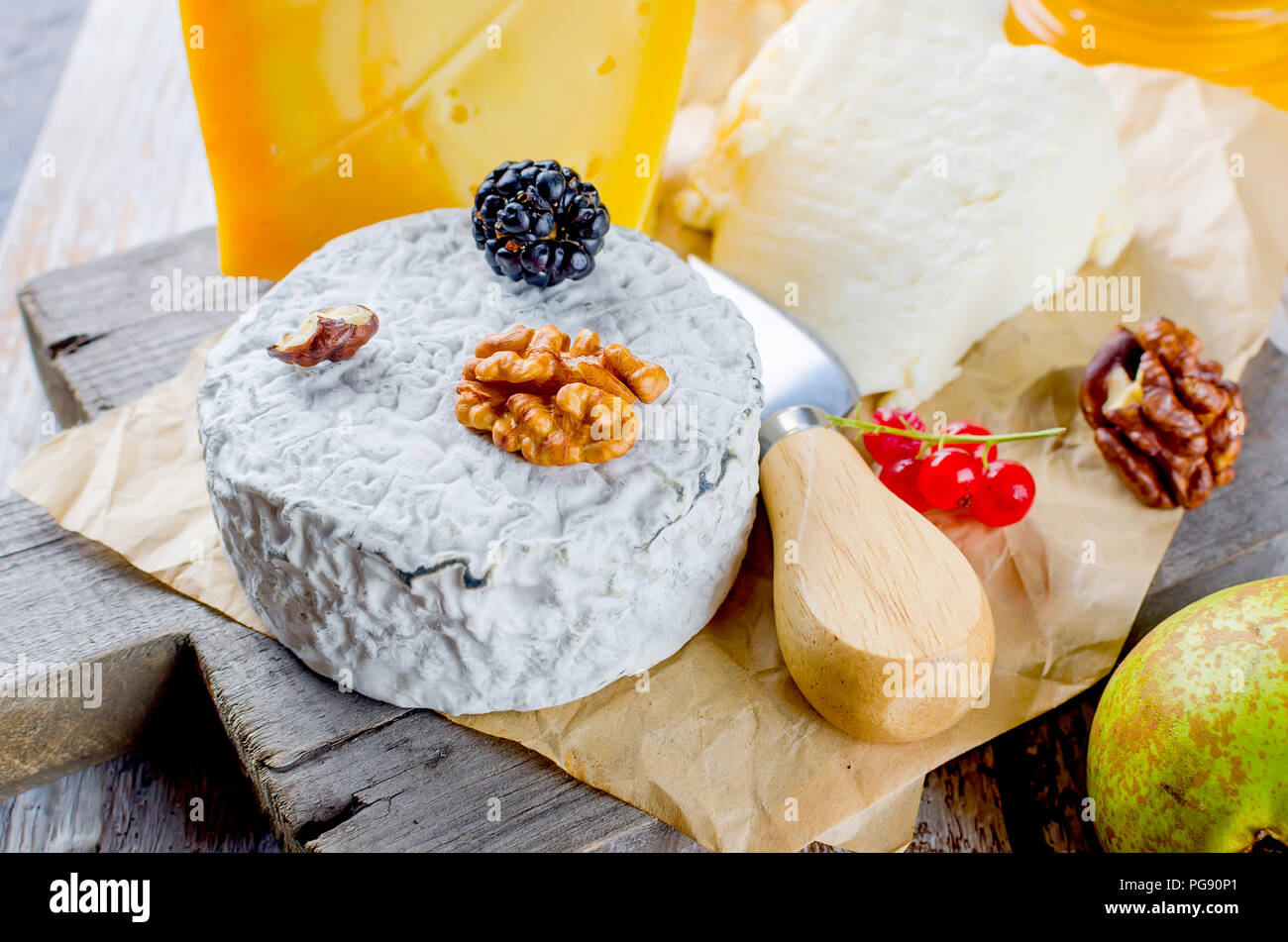 Tête de caillé de fromage bleu et olives. Le miel et poire, pomme sur la vieille table en bois blanc, vue du dessus Banque D'Images