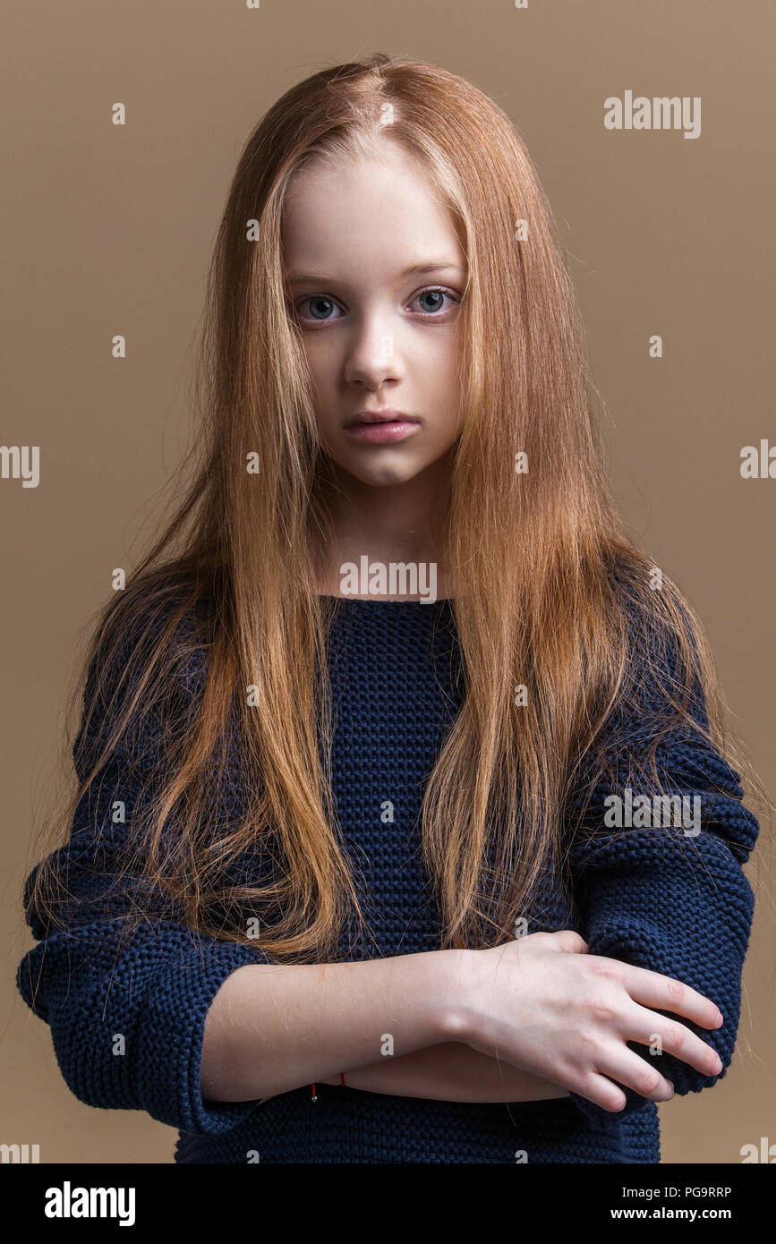 Close-up portrait of beautiful young redhead en studio sur fond beige Banque D'Images